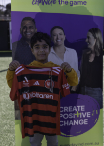 Positive Change Push: Young Boy holding Wanderers footy jersy 