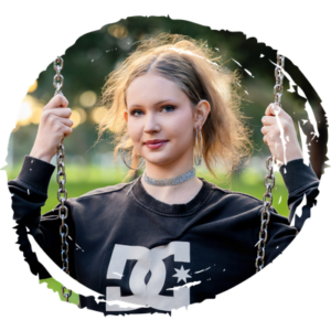 Young woman enjoying a swing in a community park.