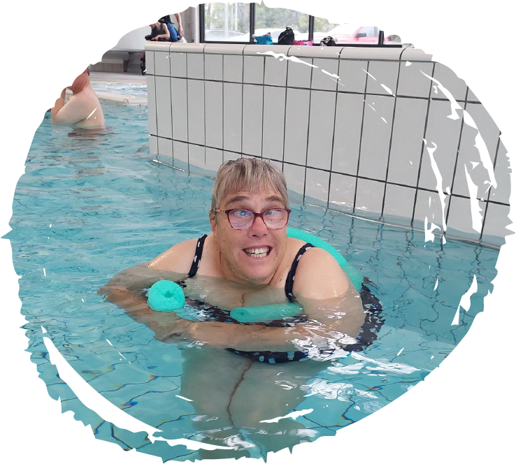 Leigh floats on a noodle inside the swimming pool