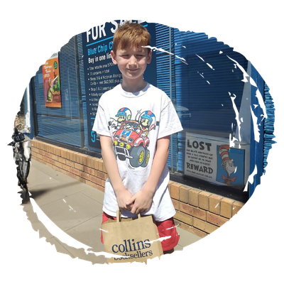 Young boy holding bag of books